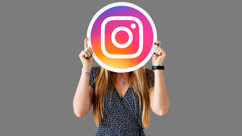 Woman showing an Instagram icon